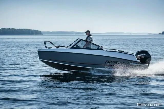 A person driving a Falcon 620 DF boat on calm waters, showcasing the Mercury engine and serene surroundings.